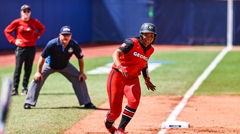 Georgia outfielder Jaiden Fields (3) takes a lead at third base as coach Lu Harris-Champer (l) looks on in the background. Fields scored a run for Georgia, but the third-base coaching decisions cost the Bulldogs one run and possibly two in a 3-2 loss to No. 5 Oklahoma State on Tuesday, June 3, 2021, in Oklahoma City. (Photo by Tony Walsh)