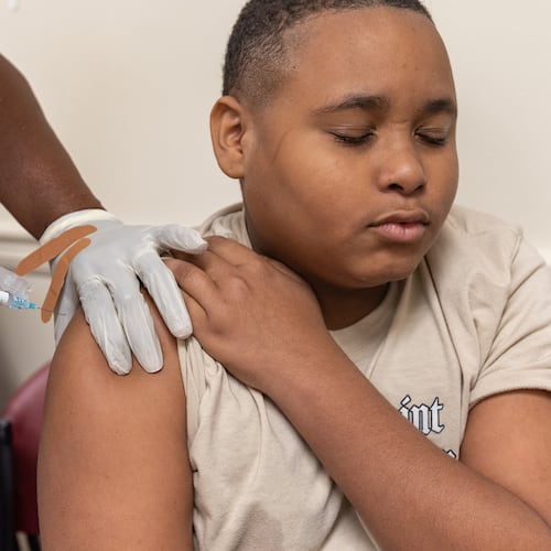 King Taylor, 13, gets a back-to-school vaccine shot at Clifton Springs Health Center in Decatur on Tuesday, July 22, 2025. (Arvin Temkar/AJC)