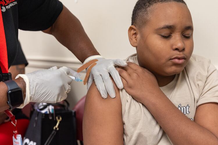 King Taylor, 13, gets a back-to-school vaccine shot at Clifton Springs Health Center in Decatur on Tuesday, July 22, 2025. (Arvin Temkar/AJC)