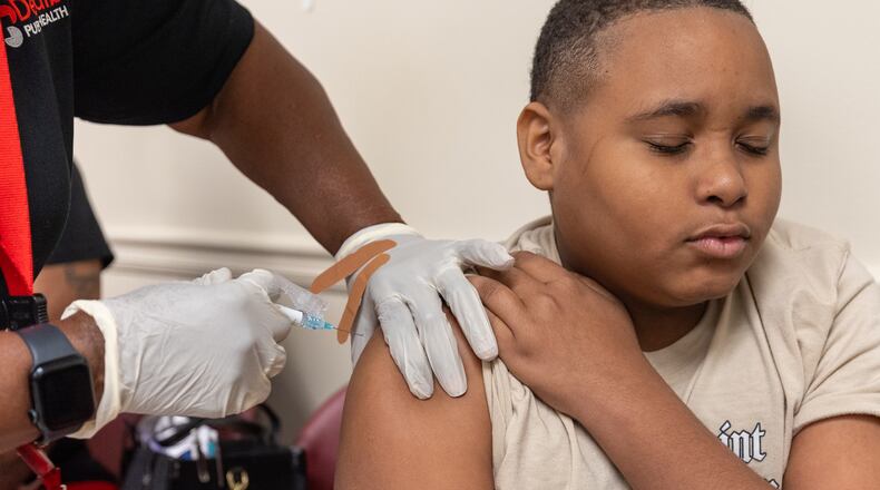 King Taylor, 13, gets a back-to-school vaccine shot at Clifton Springs Health Center in Decatur on Tuesday, July 22, 2025. (Arvin Temkar/AJC)