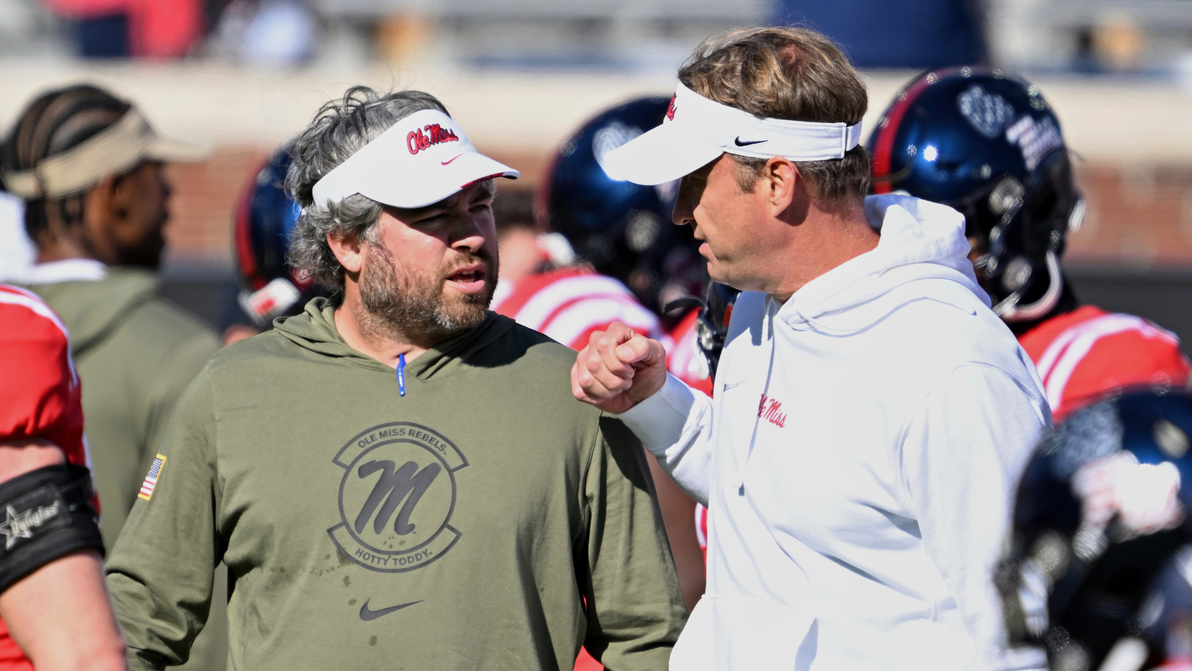 Mississippi defensive coordinator Pete Golding, left, and head coach Lane Kiffin talk during warm-ups before an NCAA college football game against Louisiana Monroe in Oxford, Miss., Saturday, Nov. 18, 2023. (Thomas Graning/AP)