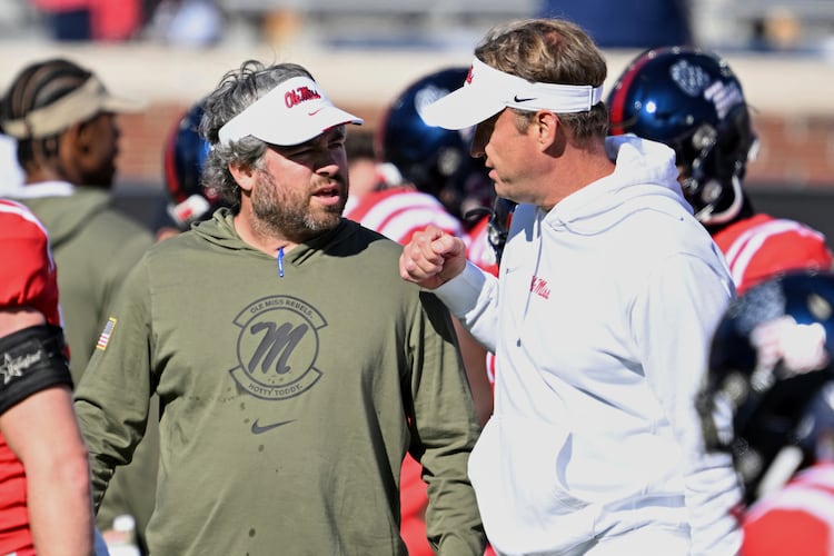 Mississippi defensive coordinator Pete Golding, left, and head coach Lane Kiffin talk during warm-ups before an NCAA college football game against Louisiana Monroe in Oxford, Miss., Saturday, Nov. 18, 2023. (Thomas Graning/AP)