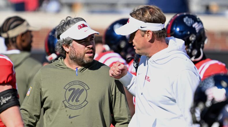 Mississippi defensive coordinator Pete Golding, left, and head coach Lane Kiffin talk during warm-ups before an NCAA college football game against Louisiana Monroe in Oxford, Miss., Saturday, Nov. 18, 2023. (Thomas Graning/AP)