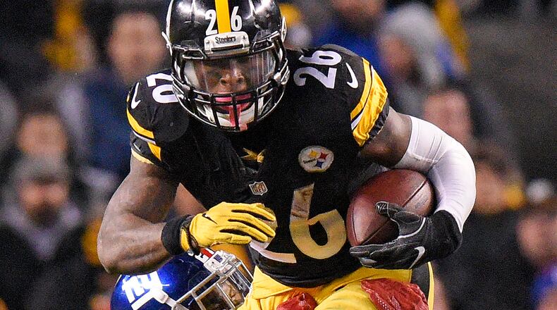 Pittsburgh Steelers running back Le'Veon Bell (26) is tackled by New York Giants strong safety Landon Collins (21) during the first half of an NFL football game in Pittsburgh, Sunday, Dec. 4, 2016. (AP Photo/Don Wright)