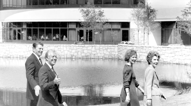 Former president Jimmy Carter gives a thumbs-up sign as he and Rosalynn give a tour of the Carter Center to President Ronald and First Lady Nancy Reagan Carter told The Atlanta Journal-Constitution that the center's accomplishments may have exceeded what he could have done through a second term as president. (Joey Ivansco/AJC 1986 file)