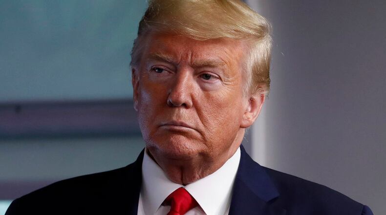 FILE - President Donald Trump and Vice President Mike Pence listen as Secretary of State Mike Pompeo speaks about the coronavirus in the James Brady Press Briefing Room of the White House, April 8, 2020, in Washington. As Trump was being arraigned in Washington on yet another round of criminal charges, his former runningmate-turned-rival Mike Pence moved to capitalize on the news, unveiling merchandise that quoted from the indictment. “Too Honest” the shirts and hats read — a reference to Trump's response when Pence rebuffed his efforts to overturn the results of the 2020 election. (AP Photo/Alex Brandon)