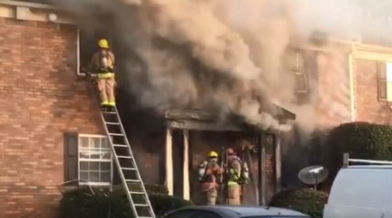 Cobb County firefighters battled a blaze Thursday at apartments near Smyrna.