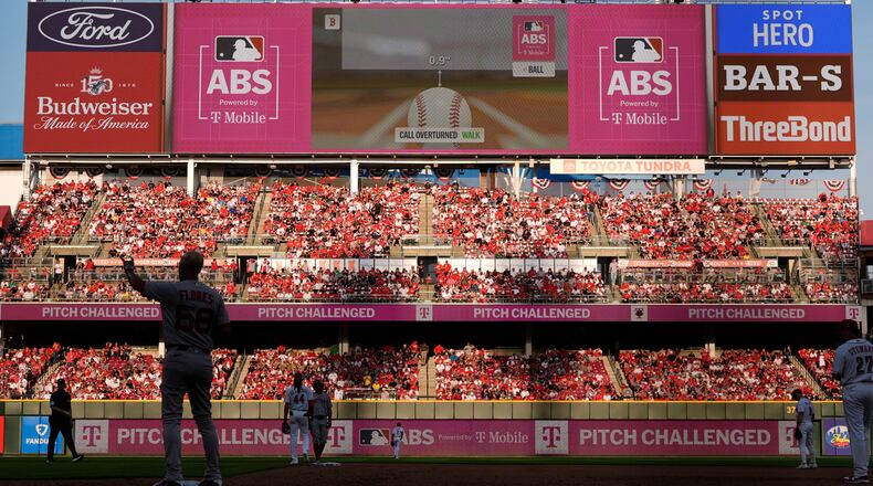 A call is overturned by Automated Ball-Strike System during the ninth inning of an opening-day baseball game between the Cincinnati Reds and the Boston Red Sox in Cincinnati, Thursday, March 26, 2026. (AP Photo/Carolyn Kaster)