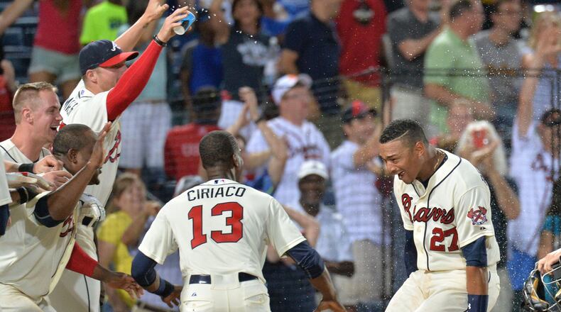 Braves catcher Christian Bethancourt (27) is mobbed by teammates after he hit game-winning home run in the ninth inning at Turner Field on Saturday, June 6, 2015. The Braves won 5-4. (HYOSUB SHIN / HSHIN@AJC.COM)