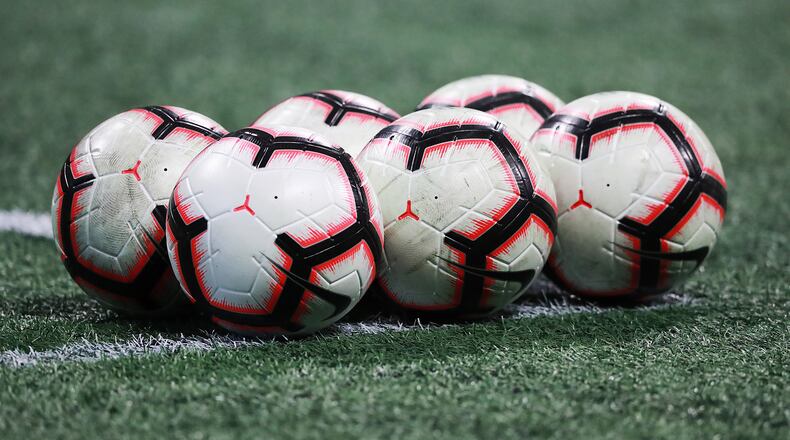 MLS soccer balls sit on the field for Atlanta United and Monterrey in thier CONCACAF Champions League quarterfinal match Wednesday, March 13, 2019, in Atlanta.