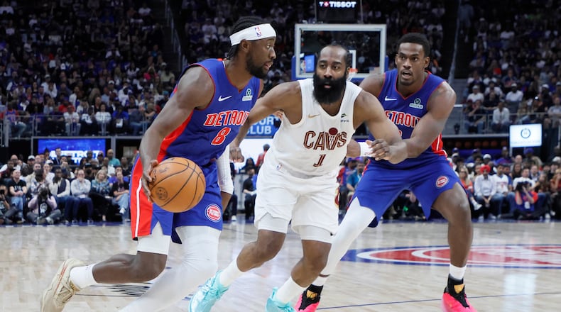 Detroit Pistons guard Caris LeVert (8) drives to the basket against Cleveland Cavaliers guard James Harden (1) with Pistons center Jalen Duren, right, helping on the play during the first half in Game 7 of a second-round NBA playoffs basketball series Sunday, May 17, 2026, in Detroit. (AP Photo/Duane Burleson)