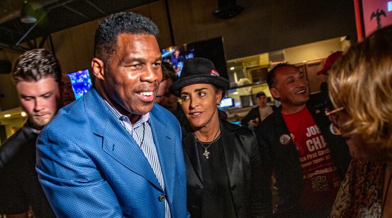 Republican U.S. Senate hopeful Herschel Walker, front left, and his wife, Julie Blanchard, center, leave Mojitos in Norcross after campaigning there in September. Republicans see an opportunity to make gains with Hispanic voters and have stepped up their outreach efforts. (Jenni Girtman for The Atlanta Journal-Constitution)
