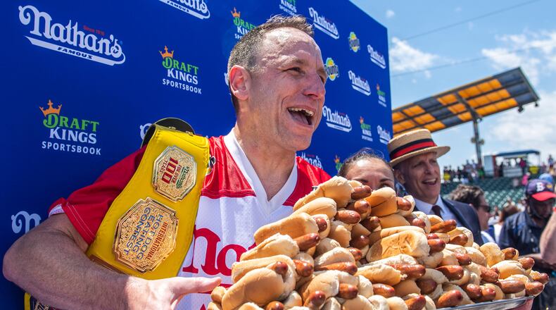FILE - Joey Chestnut, winner of the 2021 Nathan's Famous Fourth of July International Hot Dog-Eating Contest, poses for photos in Coney Island's Maimonides Park, July 4, 2021, in the Brooklyn borough of New York. (AP Photo/Brittainy Newman, File)