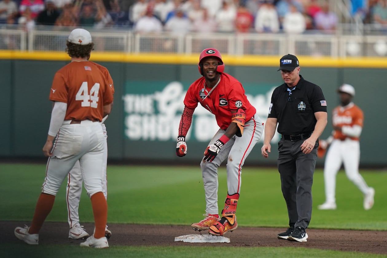 Georgia infielder Tre Phelps hits a double in the fifth inning during the elimination game against Texas in Omaha. The Bulldogs won 2-0. (Vera Nieuwenhuis/AP)