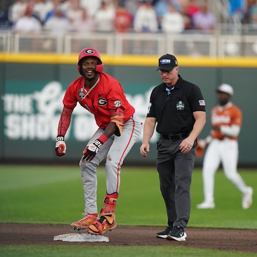 Georgia infielder Tre Phelps hits a double in the fifth inning during the elimination game against Texas in Omaha. The Bulldogs won 2-0. (Vera Nieuwenhuis/AP)