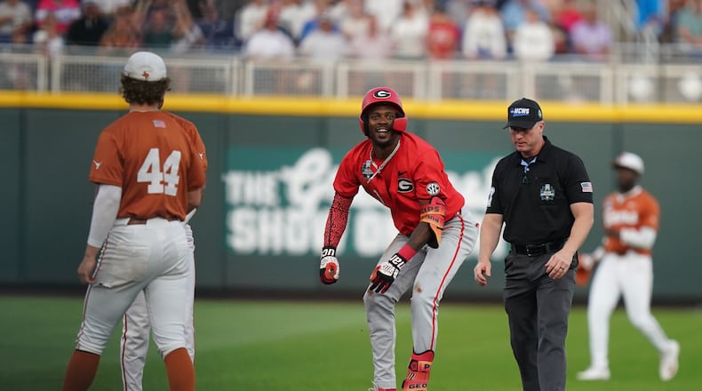 Georgia infielder Tre Phelps hits a double in the fifth inning during the elimination game against Texas in Omaha. The Bulldogs won 2-0. (Vera Nieuwenhuis/AP)