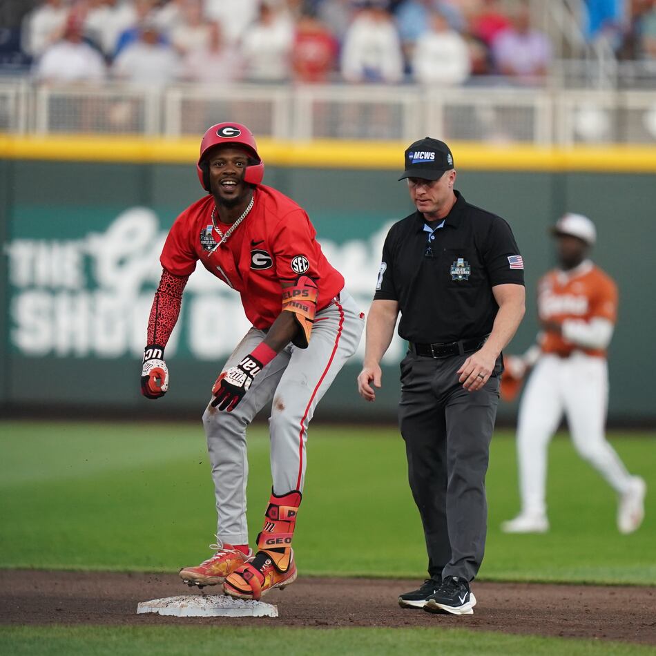 Georgia infielder Tre Phelps hits a double in the fifth inning during the elimination game against Texas in Omaha. The Bulldogs won 2-0. (Vera Nieuwenhuis/AP)