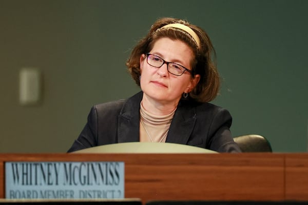 DeKalb County Board of Education member Whitney McGinniss — pictured listening during a DeKalb County School Board meeting in April — said she was against the idea of "trying to market to families to get them to come back" to DeKalb public schools. (Jason Getz/AJC)