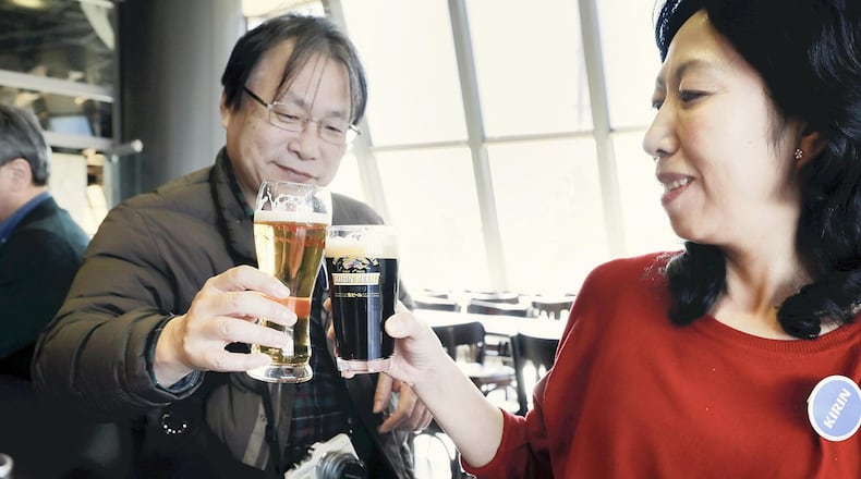 Visitors to the Kirin Brewery in Yokohama, Japan, top of their visit with a toast. Japan News-Yomiuri photo