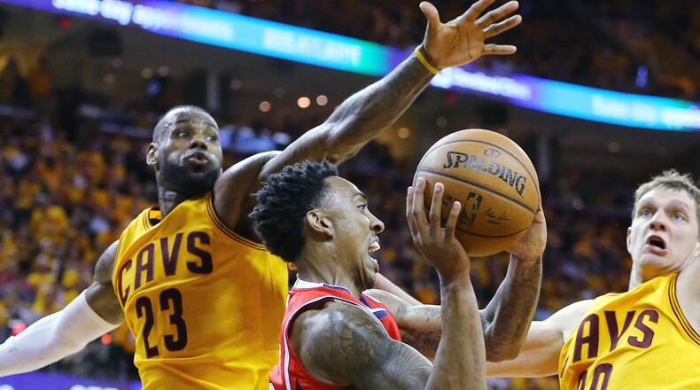 Hawks’ Jeff Teague looks to pass off under the basket drawing a double team from Cavaliers’ LeBron James and Timofey Mozgov in Game 4 of the Eastern Conference Finals on Tuesday, May 26, 2015, in Cleveland. Curtis Compton / ccompton@ajc.com