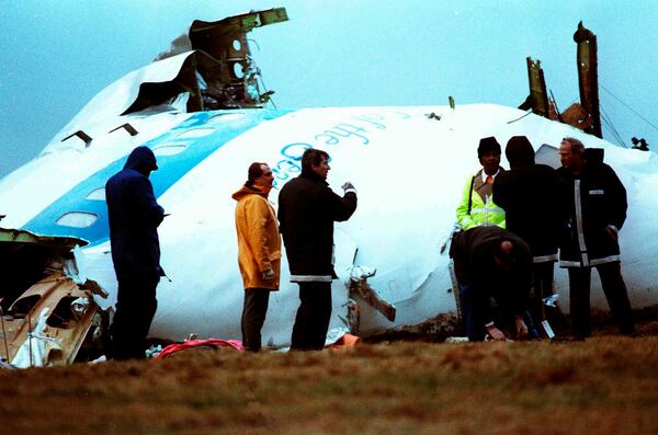 FILE - Investigators inspect the nose section of the crashed Pan Am flight 103, a Boeing 747 airliner in a field near Lockerbie, Scotland, Dec. 23, 1988. (AP Photo/Dave Caulkin, File)