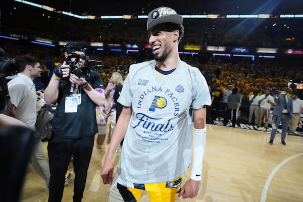 Indiana Pacers guard Tyrese Haliburton, center, reacts after winning Game 6 of the Eastern Conference finals of the NBA basketball playoffs against the New York Knicks in Indianapolis, Saturday, May 31, 2025. (AP Photo/Michael Conroy)