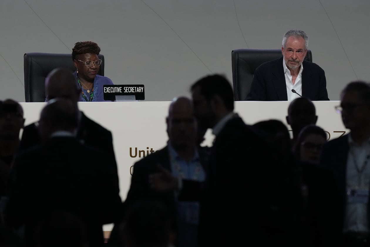 People come and go from a plenary session as André Corrêa do Lago, COP30 president, sits at back right, during the COP30 U.N. Climate Summit, Monday, Nov. 17, 2025, in Belem, Brazil. (AP Photo/Fernando Llano)