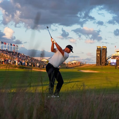 Wyndham Clark hits from the rough on the 18th hole during the third round of the U.S. Open golf tournament at Shinnecock Hills Golf Club in Southampton, N.Y., Saturday, June 20, 2026.(AP Photo/George Walker IV)