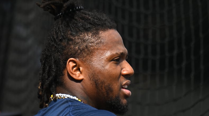 Atlanta Braves right fielder Ronald Acuna Jr. talks with teammates and coaching staff before taking batting practice during spring training workouts at CoolToday Park, Feb. 16, 2024, in North Port, Florida. (Hyosub Shin / Hyosub.Shin@ajc.com)