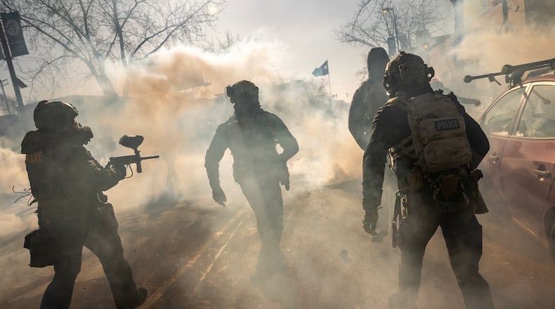 Federal agents deploy tear gas as they confront protestors in Minneapolis, near the intersection of 26th Street and Nicollet Avenue, where federal law enforcement agents shot Alex Jeffrey Pretti earlier on Saturday, Jan. 24, 2026. The shooting two weeks after an ICE agent's killing of Renee Good prompted escalating clashes between law enforcement and protesters. (David Guttenfelder/The New York Times)