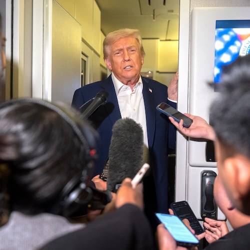 President Donald Trump speaks to reporters aboard Air Force One en route to Asia, Friday, Oct. 24, 2025. (AP Photo/Mark Schiefelbein)