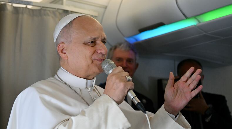 Pope Leo XIV speaks to journalists aboard his flight bound for Algiers’ Houari Boumédiène International Airport on Monday, April 13, 2026, at the start of an 11-day apostolic journey to Africa. (Alberto Pizzoli/Pool Photo via AP)