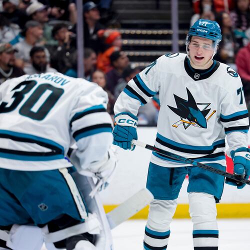 FILE - San Jose Sharks center Macklin Celebrini, right, talks with goaltender Yaroslav Askarov during the third period of an NHL hockey game against the Anaheim Ducks, April 9, 2026, in Anaheim, Calif. (AP Photo/Ryan Sun, File)