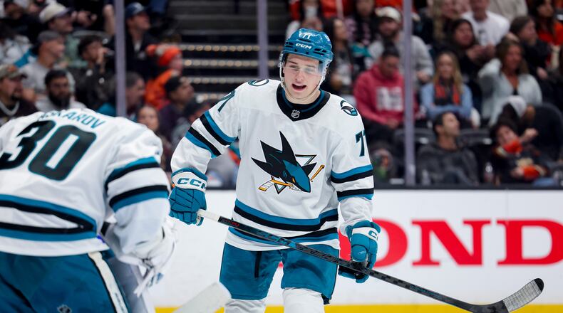 FILE - San Jose Sharks center Macklin Celebrini, right, talks with goaltender Yaroslav Askarov during the third period of an NHL hockey game against the Anaheim Ducks, April 9, 2026, in Anaheim, Calif. (AP Photo/Ryan Sun, File)