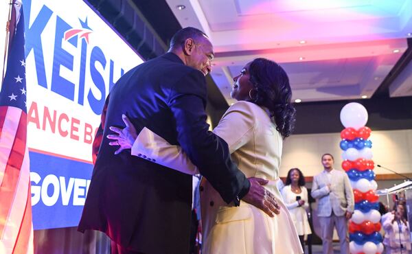 Gubernatorial candidate Keisha Lance Bottoms hugs her husband, Derek, after winning the Democratic primary election during her Election Day watch party at the Hyatt Regency on Tuesday, May 19, 2026, in Atlanta. (Natrice Miller for the AJC)