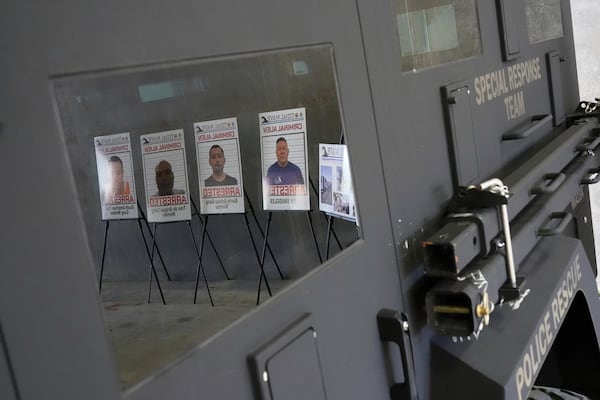 Posters of alleged criminals who officials said were arrested in a recent immigration enforcement operation are reflected in a Department of Homeland Security vehicle during a press conference with Gov. Ron DeSantis at the South Florida office of U.S. Immigration and Customs Enforcement and Enforcement and Removal Operations, Thursday, May 1, 2025, in Miramar, Fla. (AP Photo/Rebecca Blackwell)