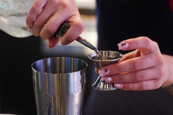 Bartender Victoria Kuchenoff makes a drink at Walk-On’s Sports Bistreaux. (Abbey Cutrer/AJC)