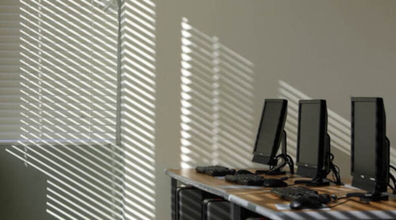 Natural light streams through large windows in a computer lab.