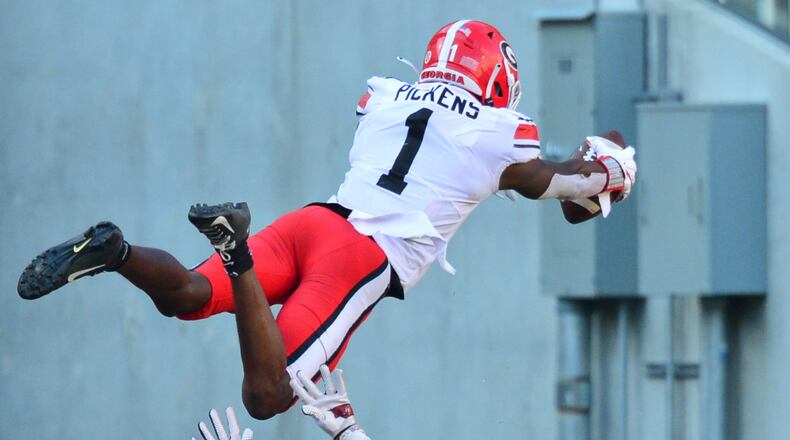 Georgia wide receiver George Pickens (1) soars over an Arkansas defender to score during the Bulldogs' win over the Razorbacks in Fayetteville, Ark., on Saturday, Sept. 26, 2020. (Photo by Gunnar Rathbun/UGA Athletics)