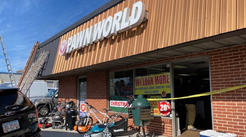 Police say the owner of Pawn World and his employee allegedly ran a fencing operation that sold stolen goods at their business. Credit: Marietta Police Department