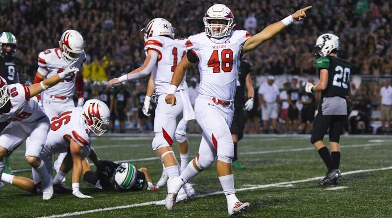 Friday Night Lights: Milton linebacker Stephen Michaels celebrates after a fumble recovery against Roswell during the first quarter of Friday's Milton-Roswell game in Roswell. (John Amis/Special)