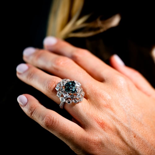A Christie's employee displays "The Ocean Dream", the largest fancy vivid blue-green diamond, weighting 5.50 carats, estimated at 7,000,000 to 10,000,000 CHF during a preview at Christie's in Geneva, Switzerland, Thursday, May 7, 2026. (Jean-Christophe Bott/Keystone via AP)