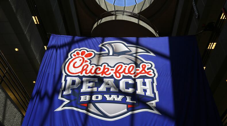 042114 ATLANTA: The new Chick-fil-A Peach Bowl logo hangs in the Chick-fil-A corporate headquarters after an unveiling ceremony on Monday, April 21, 2014, in Atlanta. CURTIS COMPTON / CCOMPTON@AJC.COM