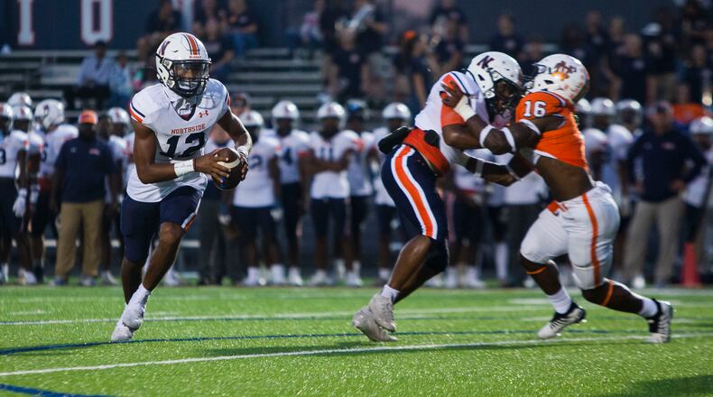 Damien Dee, quarterback for Northside, scrambles in the pocket during the North Cobb vs. Northside high school football game on Friday, September 16, 2022, in Kennesaw, Georgia. North Cobb led Northside 14-7 at the half. CHRISTINA MATACOTTA FOR THE ATLANTA JOURNAL-CONSTITUTION.