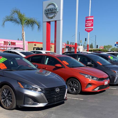 This photo provided by Edmunds shows a lineup of used vehicles at a Nissan dealership in Fresno, Calif. Certified pre-owned vehicles cost more but deliver added peace of mind through inspections by factory-trained technicians, automaker warranties, and more. (Courtesy of Edmunds via AP)