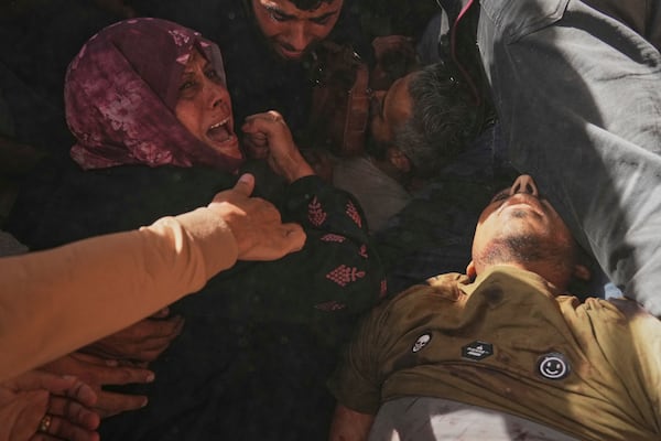A woman reacts over the bodies of some of the victims of an Israeli army strike on a restaurant, which killed at least 29 people, as they are carried from the scene to a hospital in Gaza City, Wednesday, May 7, 2025.(AP Photo/Jehad Alshrafi)