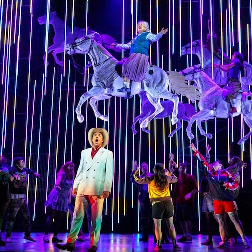 This image released by the Scottish Opera shows Justin Austin, foreground center, and Susan Bullock, top center, during a performance of "The Galloping Cure," at Theatre Royal Glasgow on July 28, 2026 in Glasgow, Scotland. (Antonia Bain/Scottish Opera via AP)