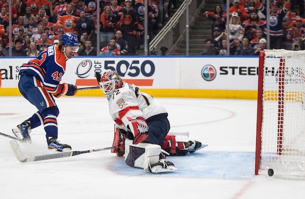 Florida Panthers goalie Sergei Bobrovsky (72) makes the save on Edmonton Oilers' Kasperi Kapanen (42) during the first overtime period in Game 1 of the NHL Stanley Cup final in Edmonton, Alberta, Wednesday, June 4, 2025. (Jason Franson/The Canadian Press via AP)
