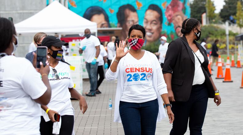 Mayor of Atlanta Keisha Lance Bottoms waves to volunteers as she walks around the Michelle Obama's nonprofit drive-thru food giveaway at The Home Depot Backyard Saturday, September 26, 2020. Event volunteers helped provide food and groceries to an estimated 2,500 attendees and prepared them to cast their ballots in November.  STEVE SCHAEFER / SPECIAL TO THE AJC