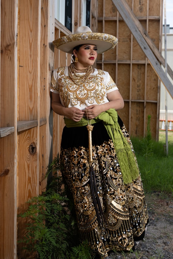 Jocelyn Correa, 19, poses at the construction site for Legacy at Herndon Square, which will become a mixed-use community in Atlanta. (Arvin Temkar/AJC)